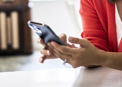 Woman using phone to transfer money