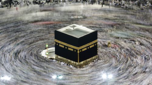 FILE - In this Aug. 13, 2019, file photo taken with a slow shutter speed, Muslim pilgrims circumambulate the Kaaba, the cubic building at the Grand Mosque, during the hajj pilgrimage in the Muslim holy city of Mecca, Saudi Arabia. 