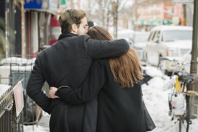 Man and woman walking down street