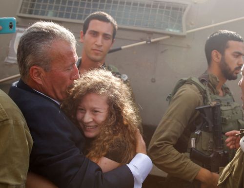 Ahed Tamimi is hugged by her father Bassem as she is released by the Israeli army Israeli prison after serving an eight month sentence. (Photo: AP).