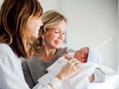 New mum and grandma holding newborn baby