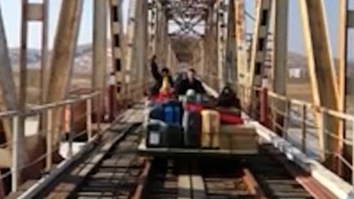 The Russian diplomat and his family crossing the bridge from North Korea into Russia.