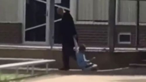 A video appears to show a school principal dragging a young student by his arm.