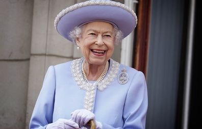 Queen Elizabeth II watches with a smile from the balcony of Buckingham Palace after the Trooping the Color ceremony in London, Thursday, June 2, 2022, on the first of four days of celebrations to mark the Platinum Jubilee.  The events over a long holiday weekend in the UK are meant to celebrate the monarch's 70 years of her service.  (Jonathan Brady/Pool Photo via AP)