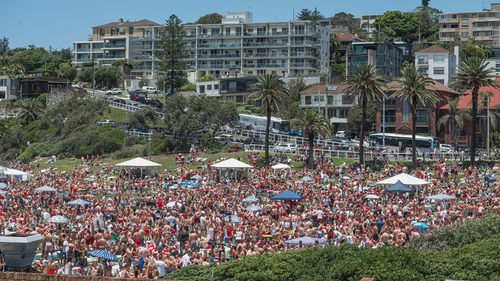 People celebrate Christmas Day at Bronte Beach in 2023.