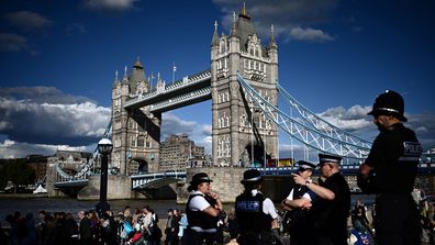 Members of the public stand in the queue near Tower Bridge, as they wait in line to pay their respects to the late Queen Elizabeth II, in London on September 16, 2022, who is lying-in-state at Westminster Abbey. - Queen Elizabeth II will lie in state until 0530 GMT on September 19, a few hours before her funeral, with huge queues expected to file past her coffin to pay their respects. (Photo by Marco BERTORELLO / AFP) (Photo by MARCO BERTORELLO/AFP via Getty Images)