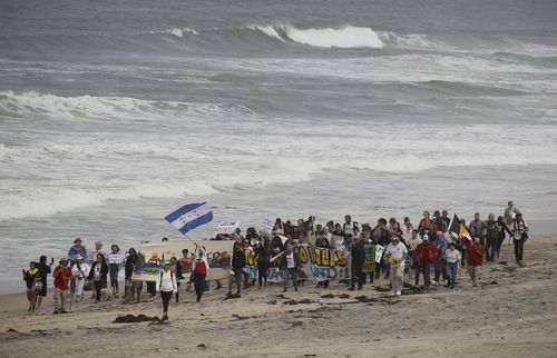 Demonstrators march to meet with Central American migrants travelling in a caravan for a gathering at the border. (AAP)