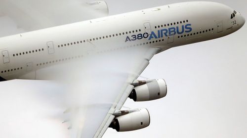 vapor forms across the wings of an Airbus A380 as it performs a demonstration flight at the 2015 Paris Air Show. (AP)