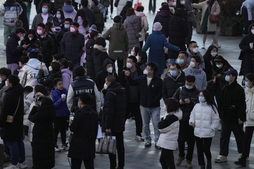 Shoppers return to a popular mall following the easing of pandemic restrictions in Beijing, Sunday, Jan. 1, 2023. 