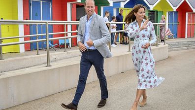 Britain's Prince William and Kate, the Duchess of Cambridge walk along the promenade in Barry Island, Wales, Wednesday Aug. 5, 2020, during their visit to speak to local business owners about the impact of COVID-19