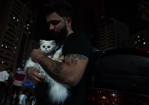 Syrian national Fadlallah Hassoun comforts his cat named Vodka after escaping a fire at a high-rise building in Sharjah