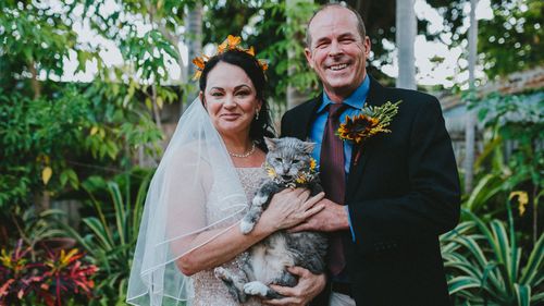 Amelia and Andrew Rankin on their wedding day in their garden- which is now devastated by the Townsville floods. 