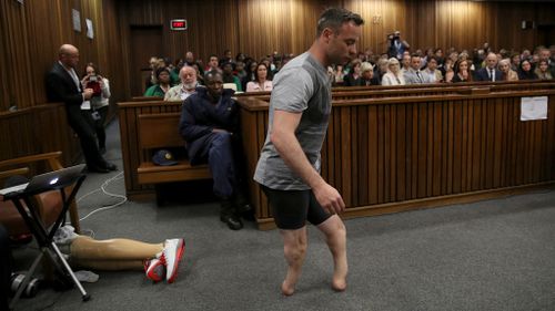 Oscar Pistorius removes his prostheses and walks on his stumps at the hearing for his murder sentence. (AAP)