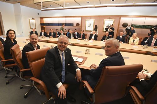 Australian Prime Minister Scott Morrison (centre) poses for photographs during his first cabinet meeting at Parliament House in Canberra