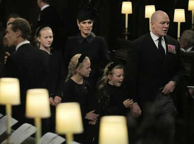 Savannah Phillips and Zara Tindall, background and Isla Phillips, Lena Tindall and Mike Tindall arrive for the Committal Service for Queen Elizabeth II held at St George's Chapel at Windsor Castle, Windsor, England, Monday Sept. 19, 2022. The Queen, who died aged 96 on Sept. 8, will be buried at Windsor alongside her late husband, Prince Philip, who died last year.