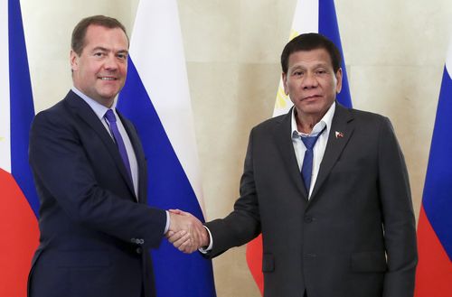 Russian Prime Minister Dmitry Medvedev, left, and Philippine President Rodrigo Duterte shake hands prior to their talks in Moscow, Wednesday, Oct. 2, 2019. (Yekaterina Shtukina, Sputnik, Government Pool Photo via AP)