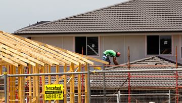A tradesman works on a building site in Sydney.