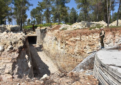 A soldier stands guard at a terrorist underground base with the capacity to host approximately a thousand people, discovered within the 'Operation Olive Branch' at a forest in the mountains in Afrin, Syria on April 13, 2018