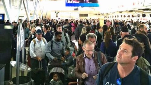 Crowds have formed as Sydney Airport have been forced to shut down the majority of its runways.