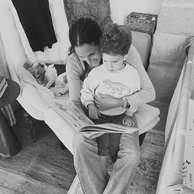 Meghan and Archie read a book