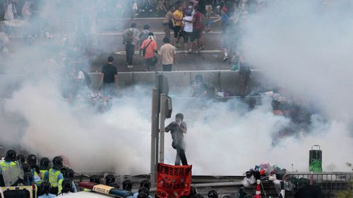 Hong Kong police used tear gas and warned of further measures as they tried to clear thousands of pro-democracy protesters. (AAP)