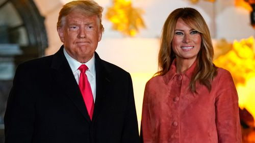 President Donald Trump and first lady Melania Trump greet trick-or-treaters on the South Lawn during a Halloween celebration at the White House