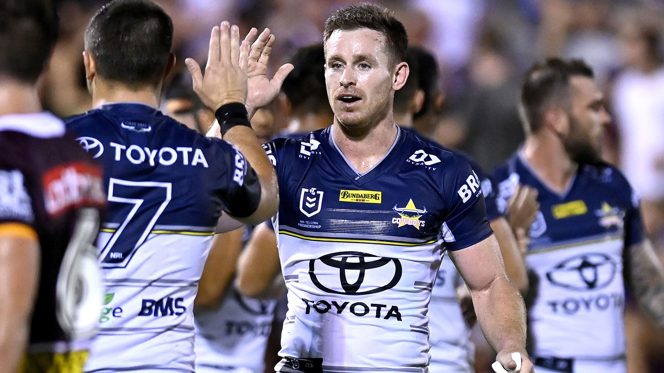Cowboys star Michael Morgan celebrates a try with Jake Clifford during a 2021 pre-season game.