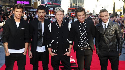 FILE - Louis Tomlinson, from left, Zayn Malik, Niall Horan, Harry Styles and Liam Payne arrive for the World Premiere of "One Direction: This Is Us," at the Empire Leicester Square, in London, Aug. 20, 2013. (Ian West/PA via AP, File)