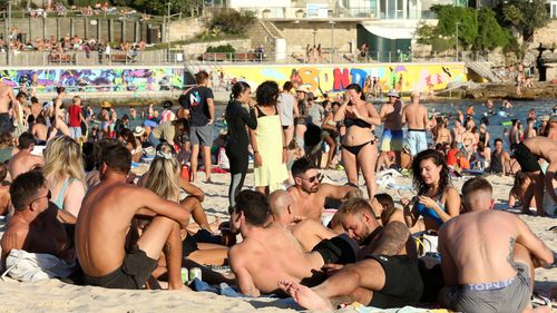 Beachgoers are seen at Bondi Beach despite the threat of Coronavirus (COVID-19) in Sydney, Friday, March 20, 2020.