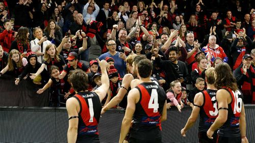 Essendon players acknowledges their fans after the round 10 AFL match between the Essendon Bombers and the North Melbourne Kangaroos at Marvel Stadium