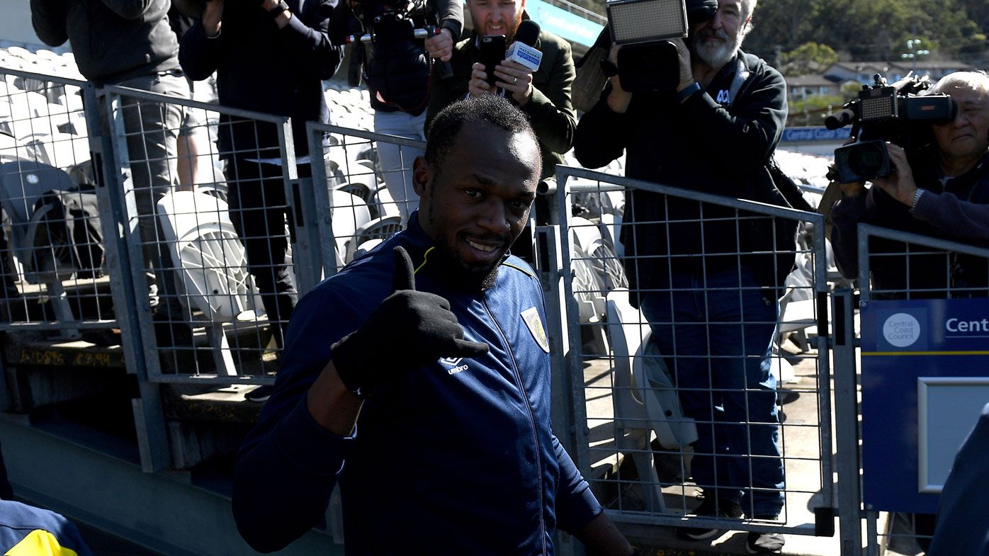 Usain Bolt plays up for the cameras at Mariners training.