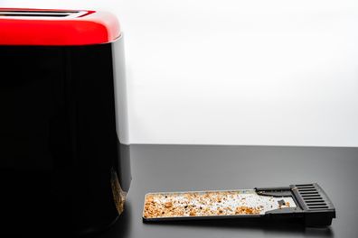 A tray full of bread crumbs from a toaster
