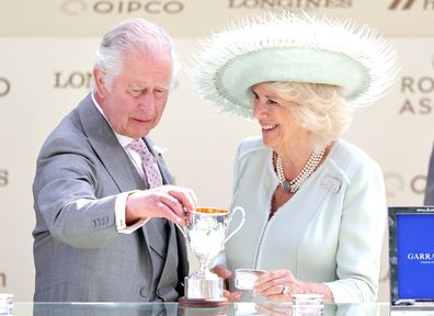 King Charles II and Queen Camilla holds the King George V Trophy after his horse horse Desert Hero won as they attend day three of Royal Ascot 2023 at Ascot Racecourse on June 22, 2023 in Ascot, England 