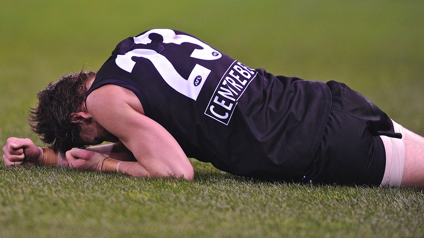 Justin Koschitzke lays on the ground after a high Chris Tarrant bump in 2011.