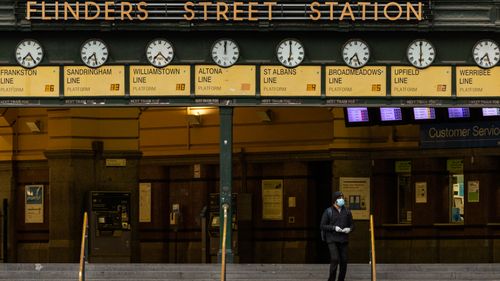 A lone commuter walks out of Flinders Street station in Melbourne, Australia. 