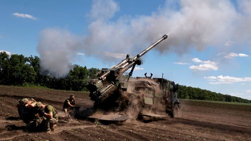 Ukrainian soldiers fire at Russian positions with a CAESAR self-propelled howitzer