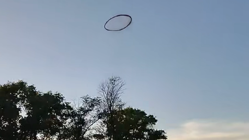 A black ring in the sky has slowly disappeared before shocked witnesses, raising questions about its origin. 