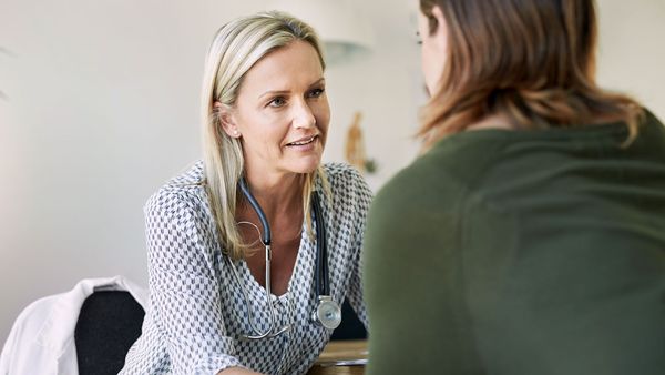 Female doctor consulting with woman