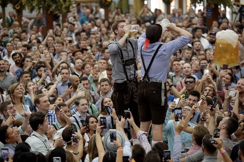 Two men drink beer during the opening of the 185th 'Oktoberfest' beer festival in Munich, Germany.