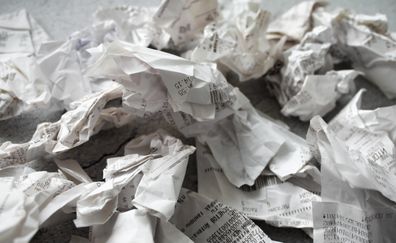 Close-up of many crumpled receipts from stores. The concept of shopping and purchases.