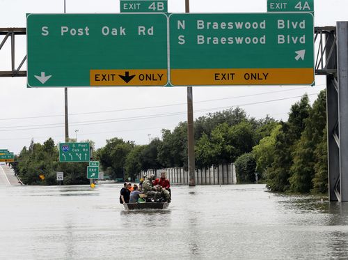 Residents are rescued from their homes surrounded by floodwaters in Houston. (AP)