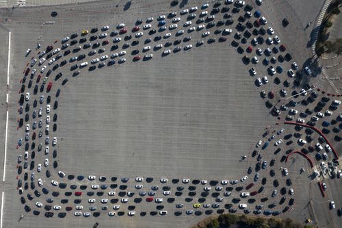 Motorists line up to take a coronavirus test in a parking lot at Dodger Stadium on Monday in Los Angeles.
