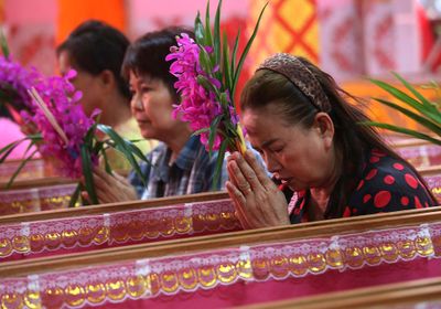 Worshippers pray as they take turns sitting in coffins at the Takien temple in suburban Bangkok, Thailand. Worshippers believe that the coffin ceremony – symbolising death and rebirth – helps them rid themselves of bad luck.