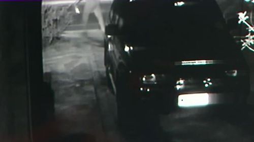 In CCTV from the Seaton house, a person is seen pouring petrol on the 4WD before lighting it on fire. (9NEWS)