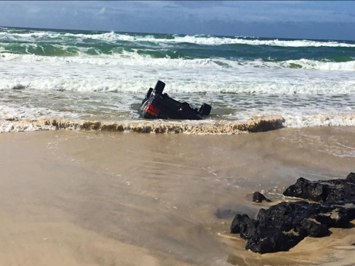 High tide prevented efforts to recover the four-wheel drive on Tuesday. (Queensland Ambulance Service)