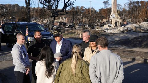 President Donald Trump and first lady Melania Trump talks with residents affected by the wildfires as they tour the Pacific Palisades neighborhood of Los Angeles, Friday, Jan. 24, 2025. (AP Photo/Mark Schiefelbein)