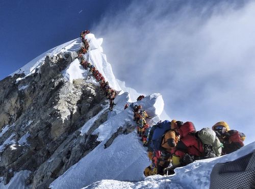 A long queue of mountain climbers line a path on Mount Everest, on May 22 last year. The photo of the world's highest mountain packed with climbers attracted worldwide attention.