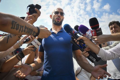 Andrew Tate speaks to media after being released from house arrest and put under judicial control measures, on the outskirts of Bucharest, Romania, Friday, Aug. 4, 2023.  