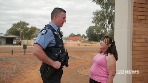 The grandmother-of-14 with Sergeant Chris Martin. (9NEWS)