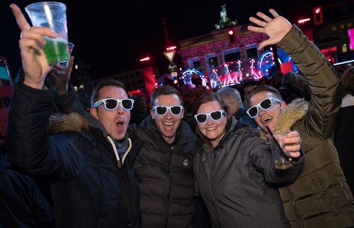 People celebrate New Year's Eve at the Brandenburg Gate in Berlin, Germany, 31 December 2017. Hundreds of thousands of revelers gather in the city center and celebrate New Year's Eve. (AAP)